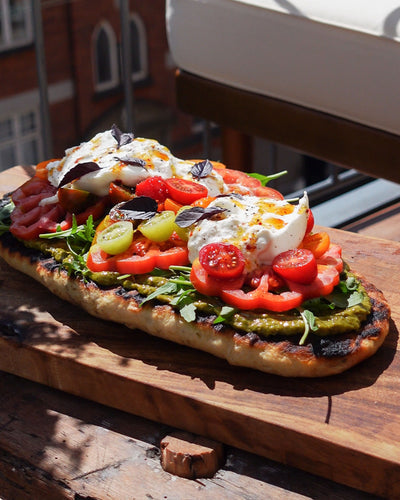 Das Rezept: Großes gegrilltes Knoblauchfladenbrot mit Burrata, Tomaten, Pesto und Limetten-Chili-Honig